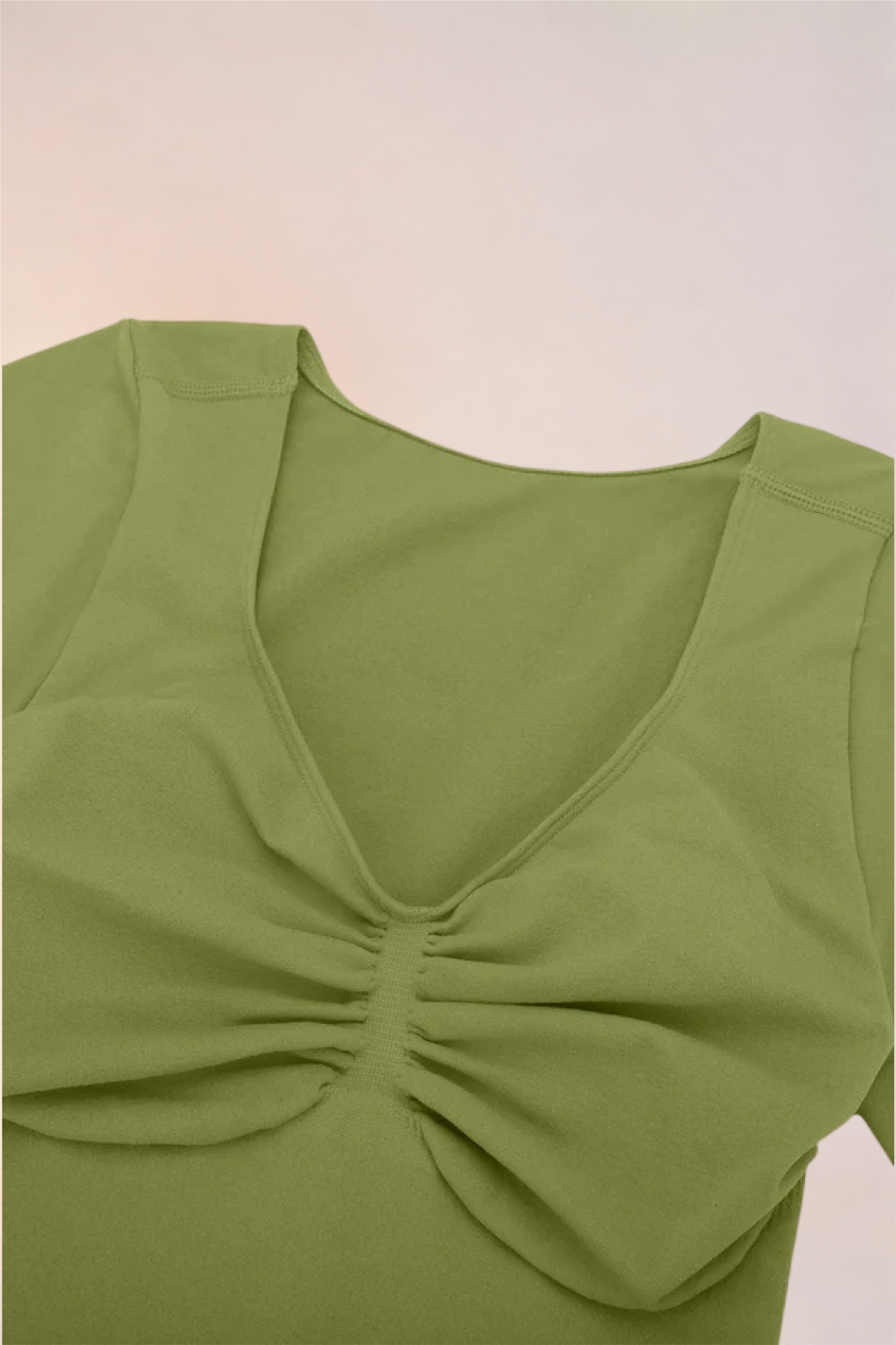 Flat lay of the Skinzform Contour Bodysuit in Olive showing the V-neckline and ruching