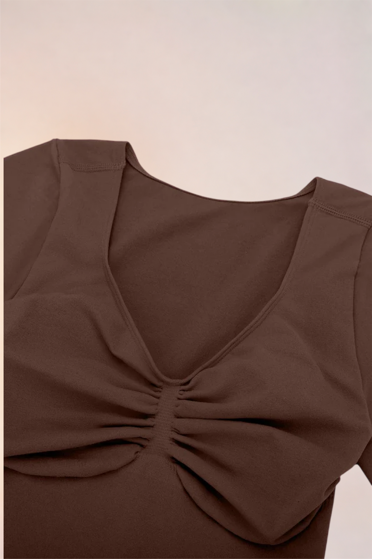 Flat lay of the Skinzform Contour Bodysuit in Cacao showing the V-neckline and ruching
