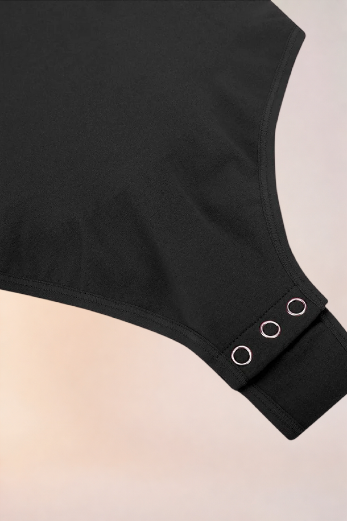Flat lay of the Skinzform Contour Bodysuit in Noir showing the snap gusset