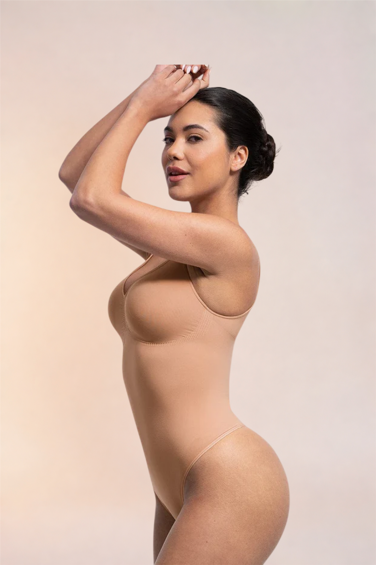 Skinzform Diamant Bodysuit in Nude, side view on the model with one arm raised