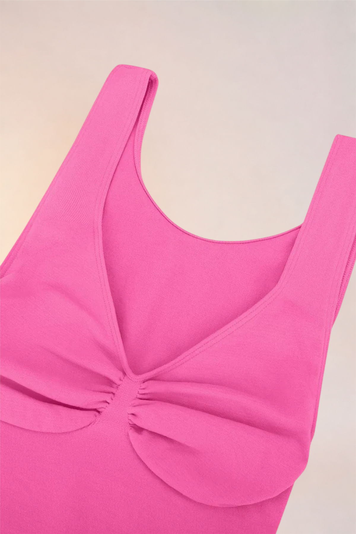 Flat lay of the Skinzform Diamant Bodysuit in Rose showing the gathered bust panel
