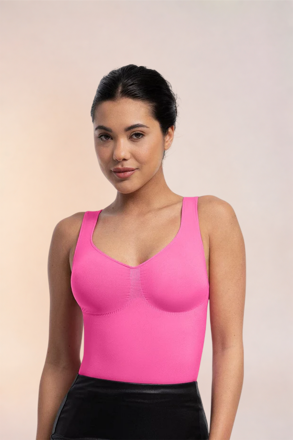 Skinzform Diamant Bodysuit in Rose styled with a black leather skirt, half-length front view