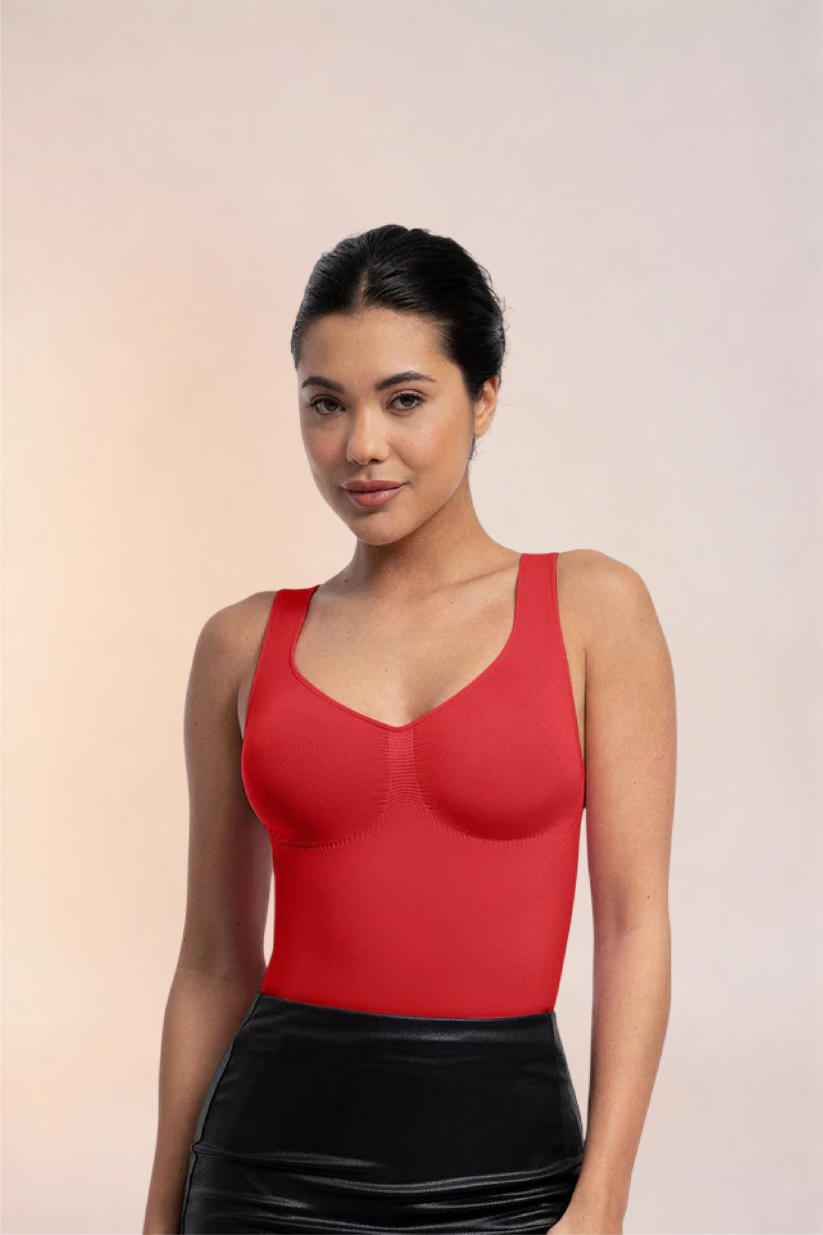 Skinzform Diamant Bodysuit in Rouge styled with a black leather skirt, half-length front view