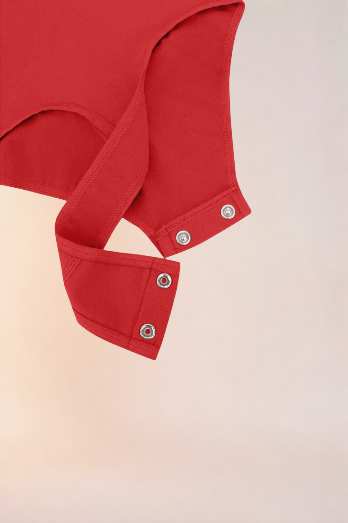 Flat lay of the Skinzform Diamant Bodysuit in Rouge showing the snap gusset