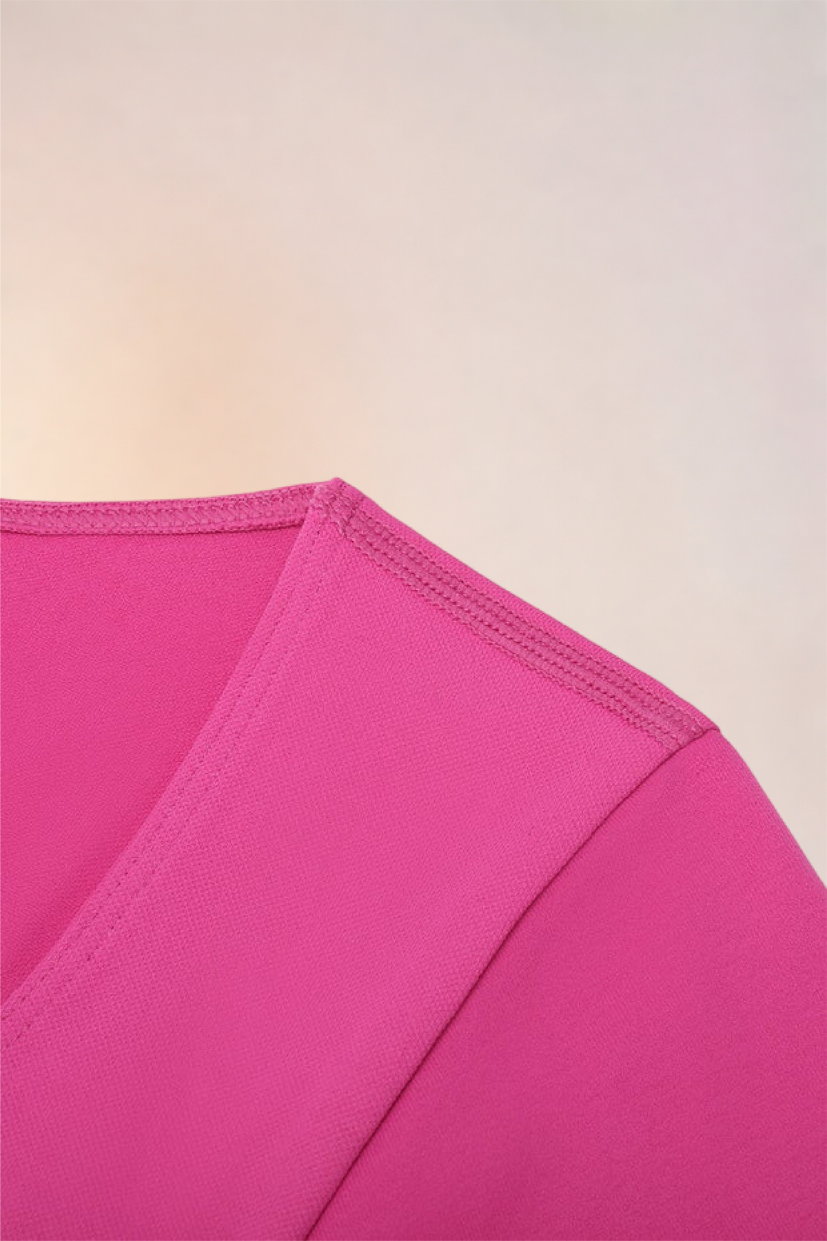 Close-up of the shoulder seam and sleeve on the Skinzform Diamant Top in Rose