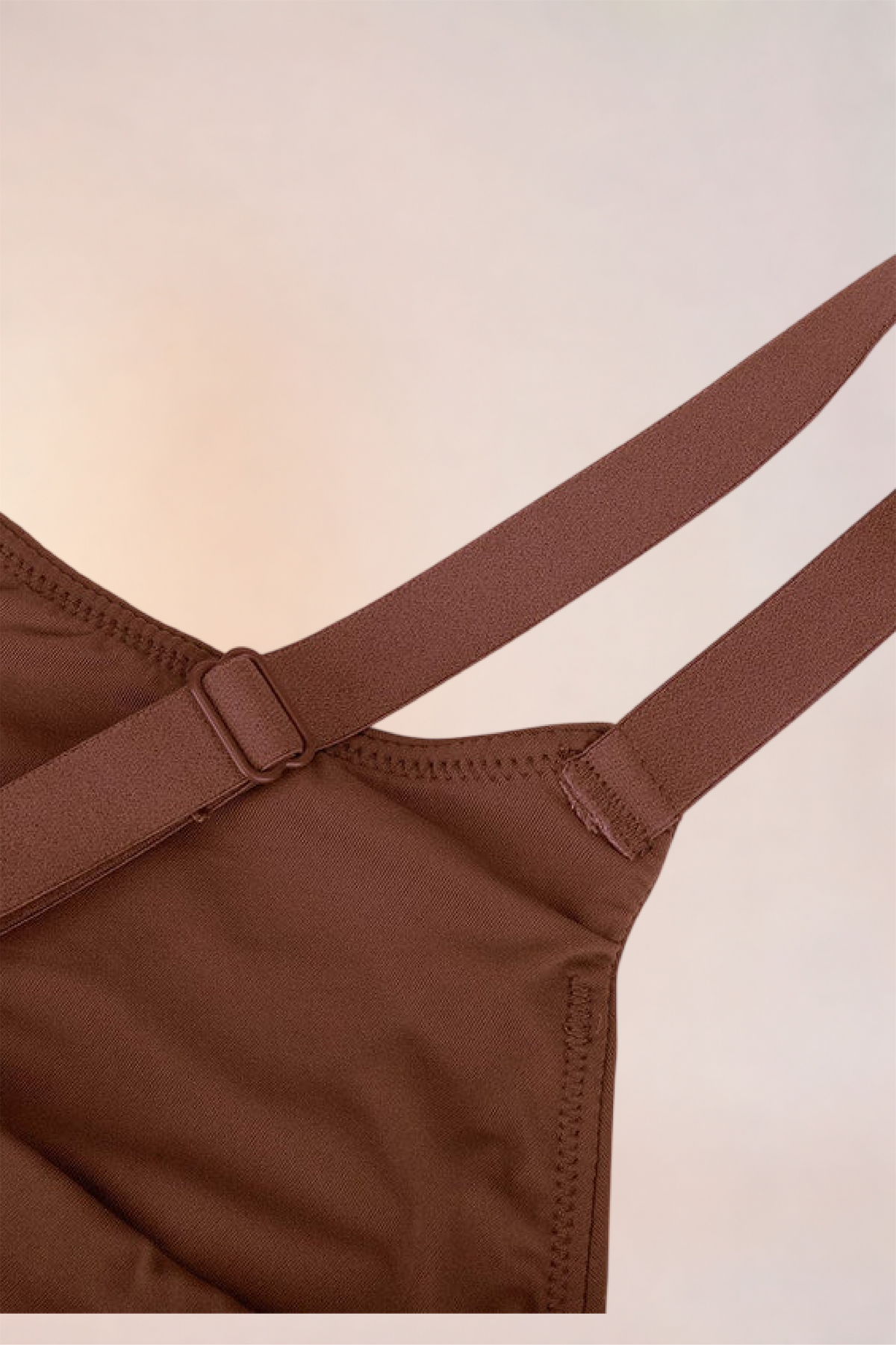 Flat lay of the Skinzform Doux Bralette in Cacao showing the strap slider and cup edge