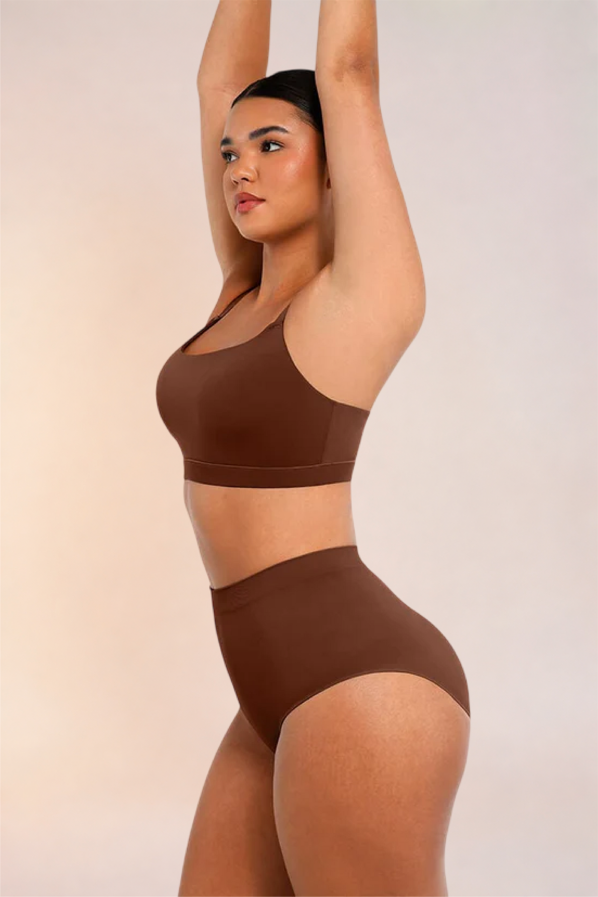 Skinzform Doux Bralette in Cacao worn with matching briefs, side view with arms raised