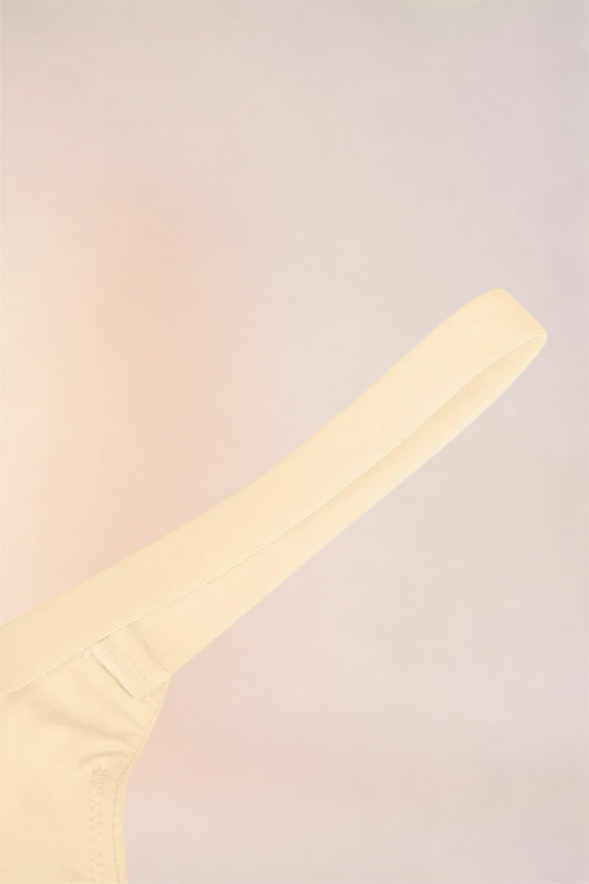 Flat lay of the adjustable strap on the Skinzform Doux Bralette in Nude