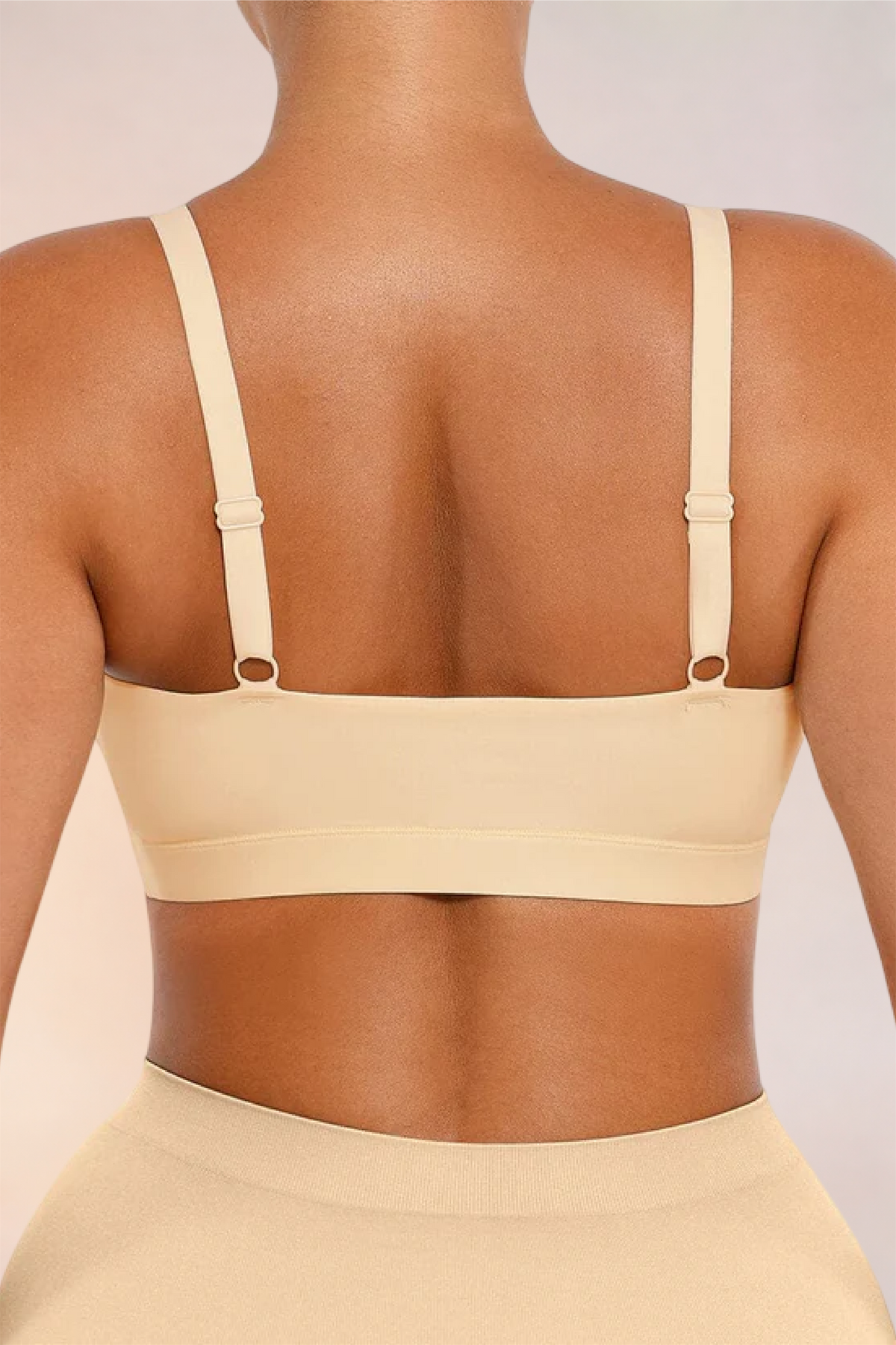 Close-up of the adjustable back straps on the Skinzform Doux Bralette in Nude