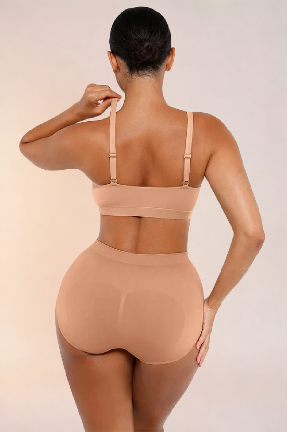 Skinzform Doux Bralette in Beige worn with matching briefs, back view - reaching for the strap