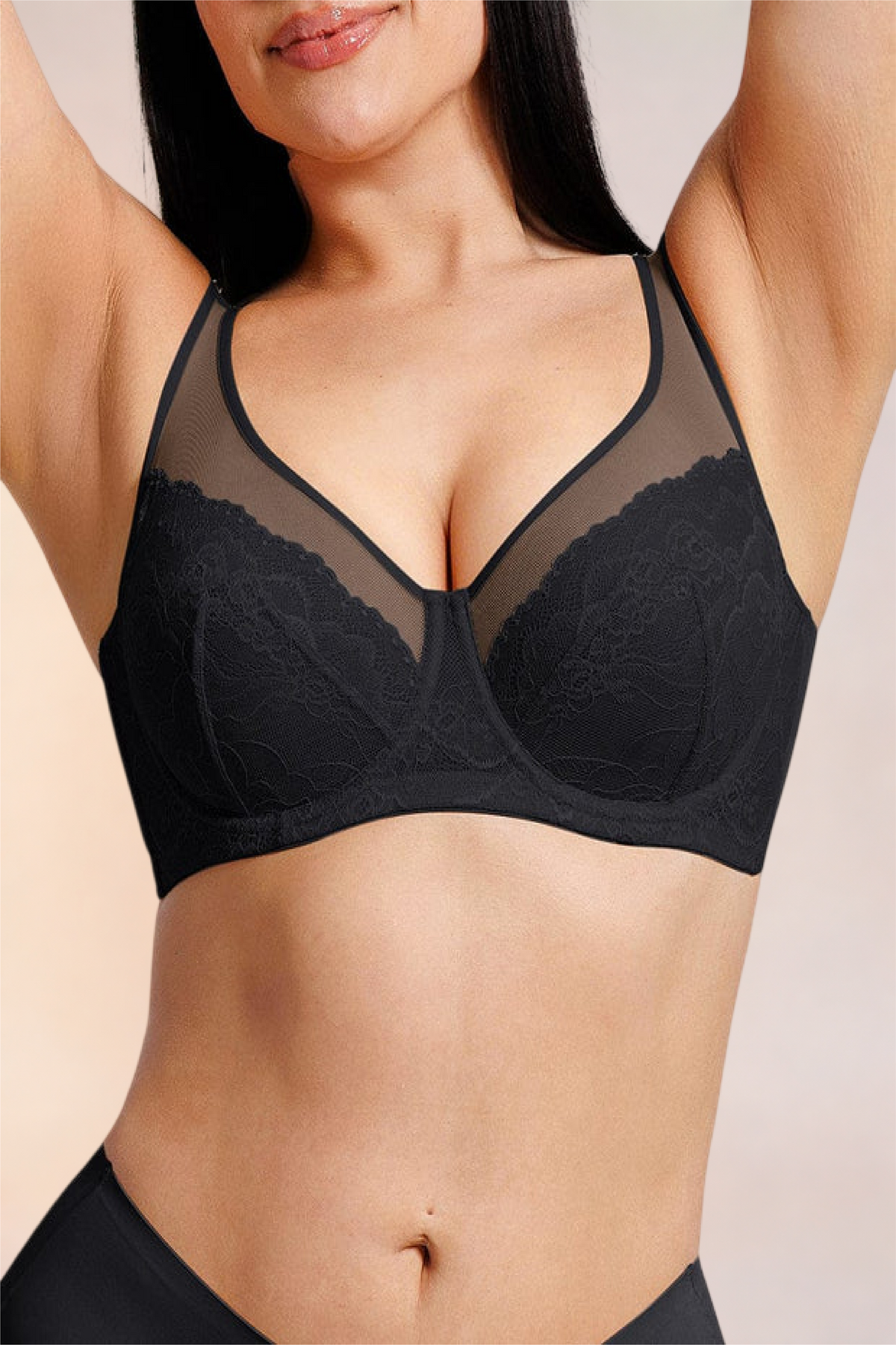 Skinzform Élégance Bra in Noir, front view on the model with arms raised