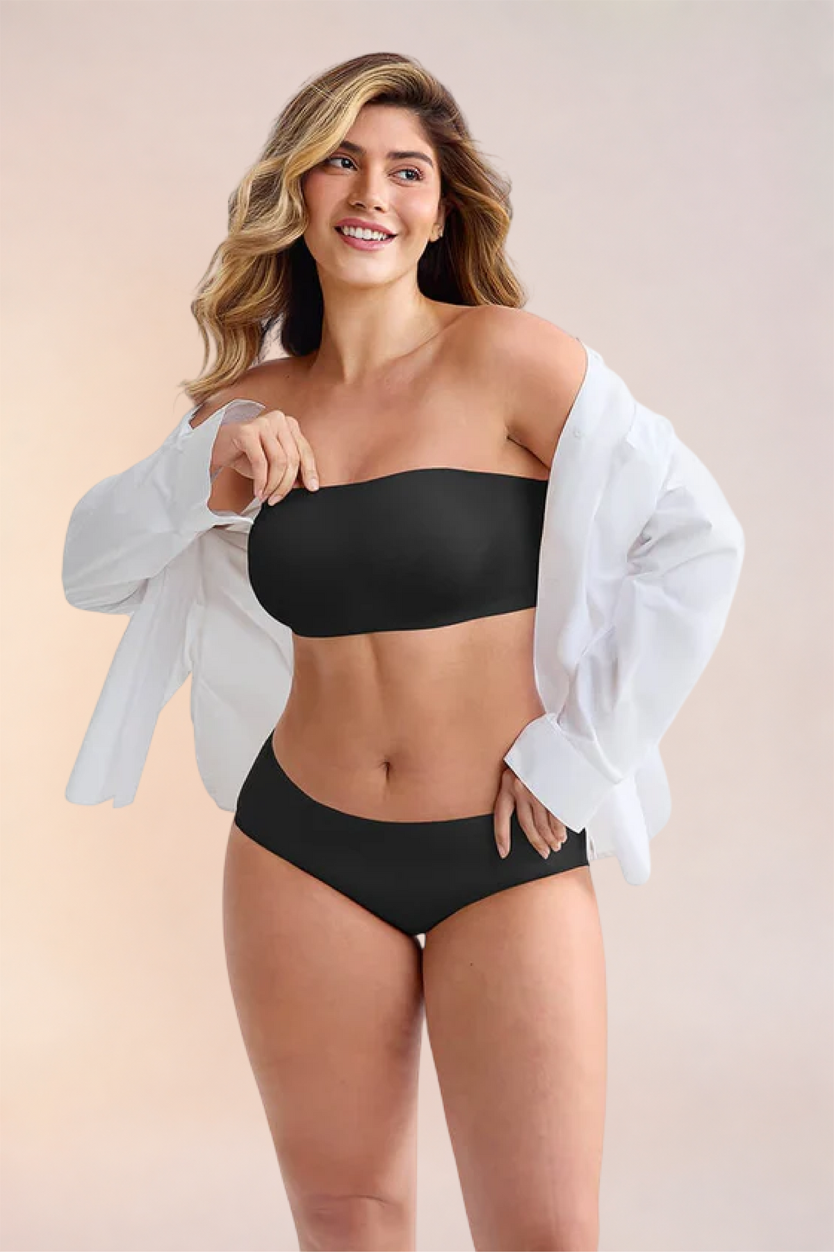 Skinzform Libre Bandeau in Noir worn with an open white shirt, hand at the hip