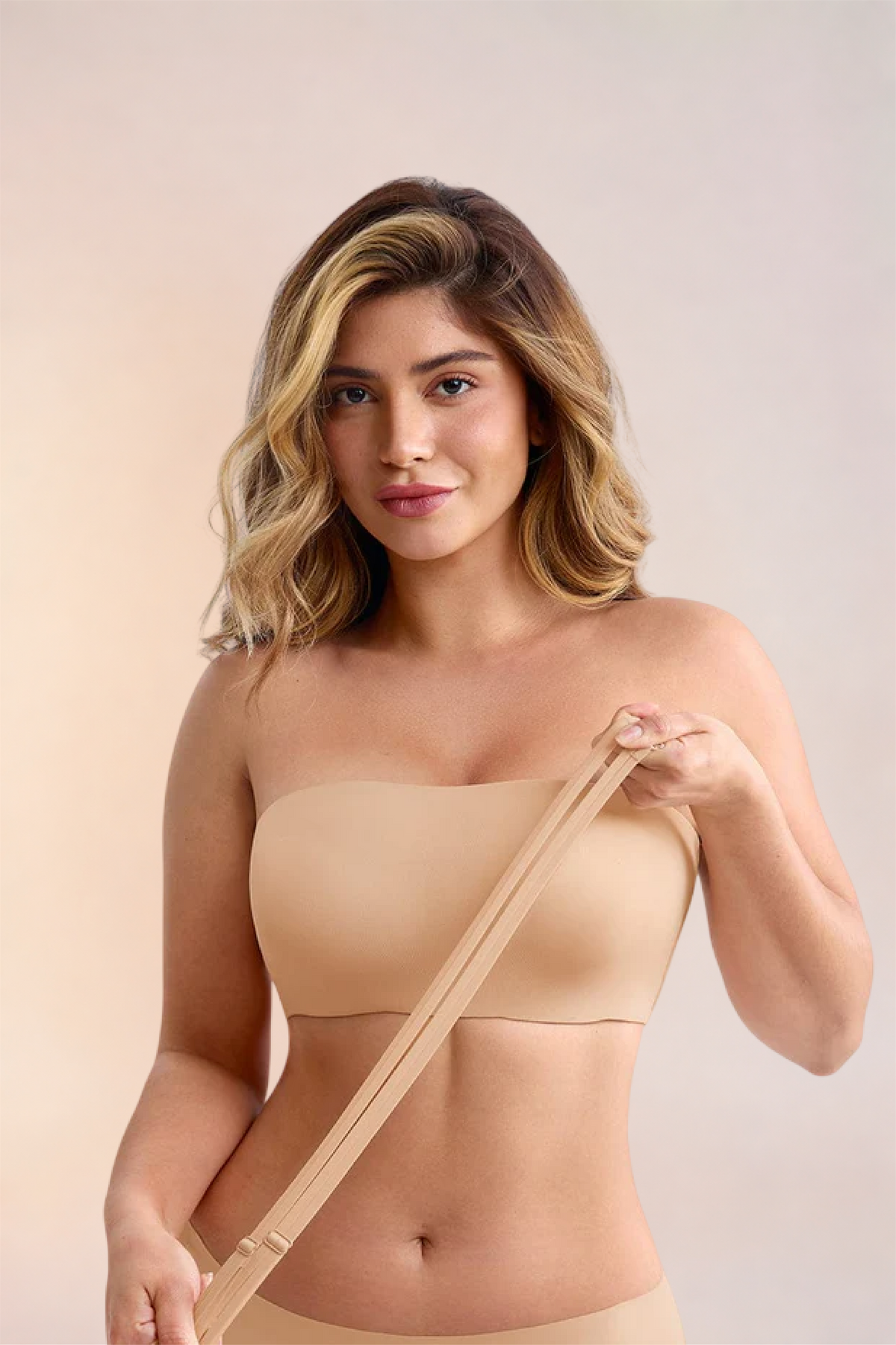 Skinzform Libre Bandeau in Nude - model holding the detachable strap