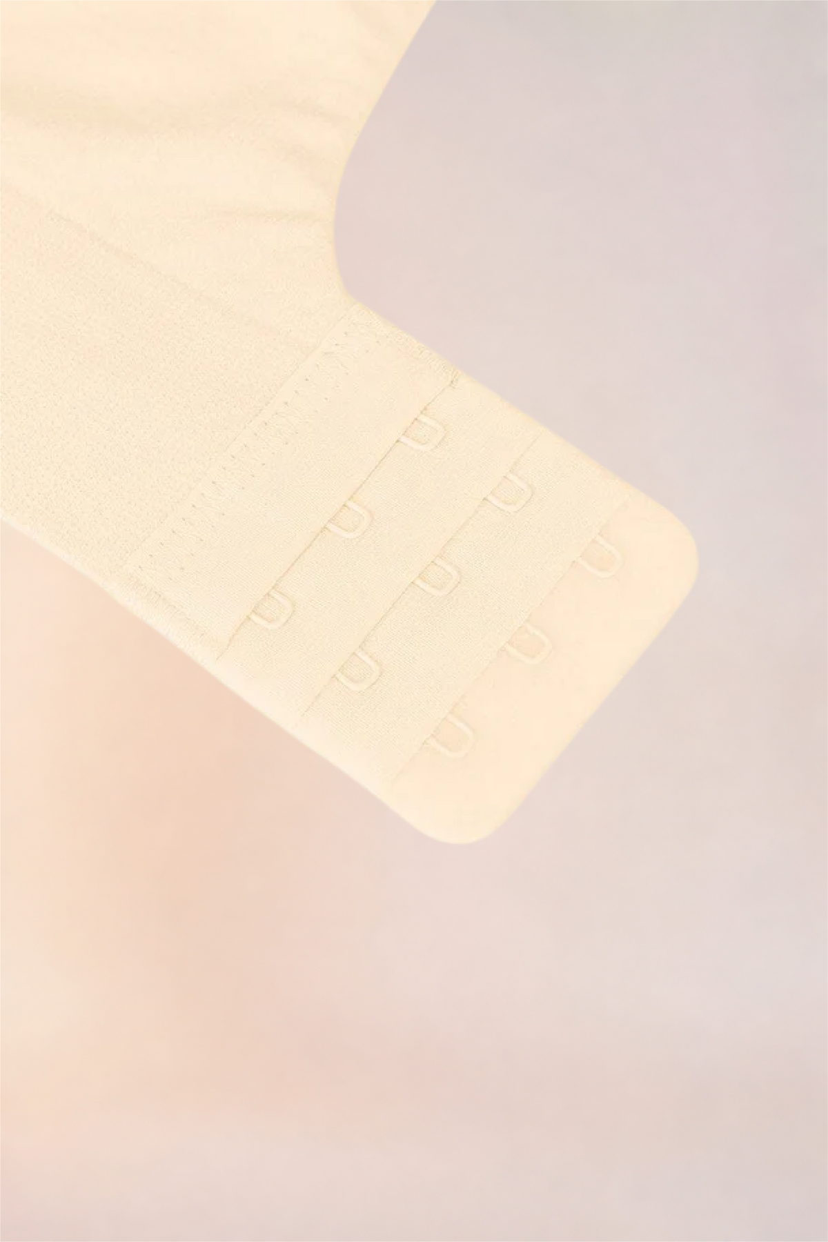 Flat lay of the Skinzform Nuage Bra in Nude showing the hook-and-eye band