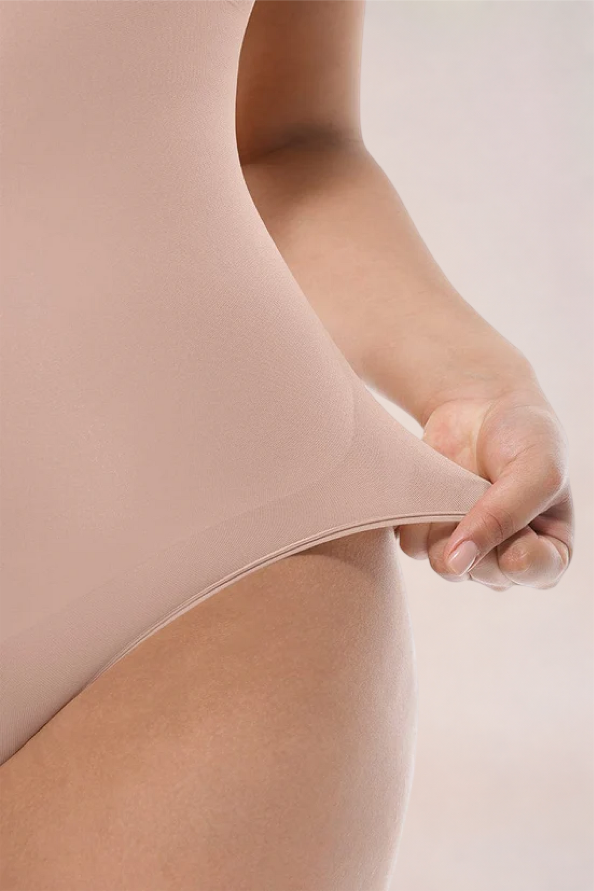 Skinzform Core Brief in Nude - fabric stretched at the hip to show the give