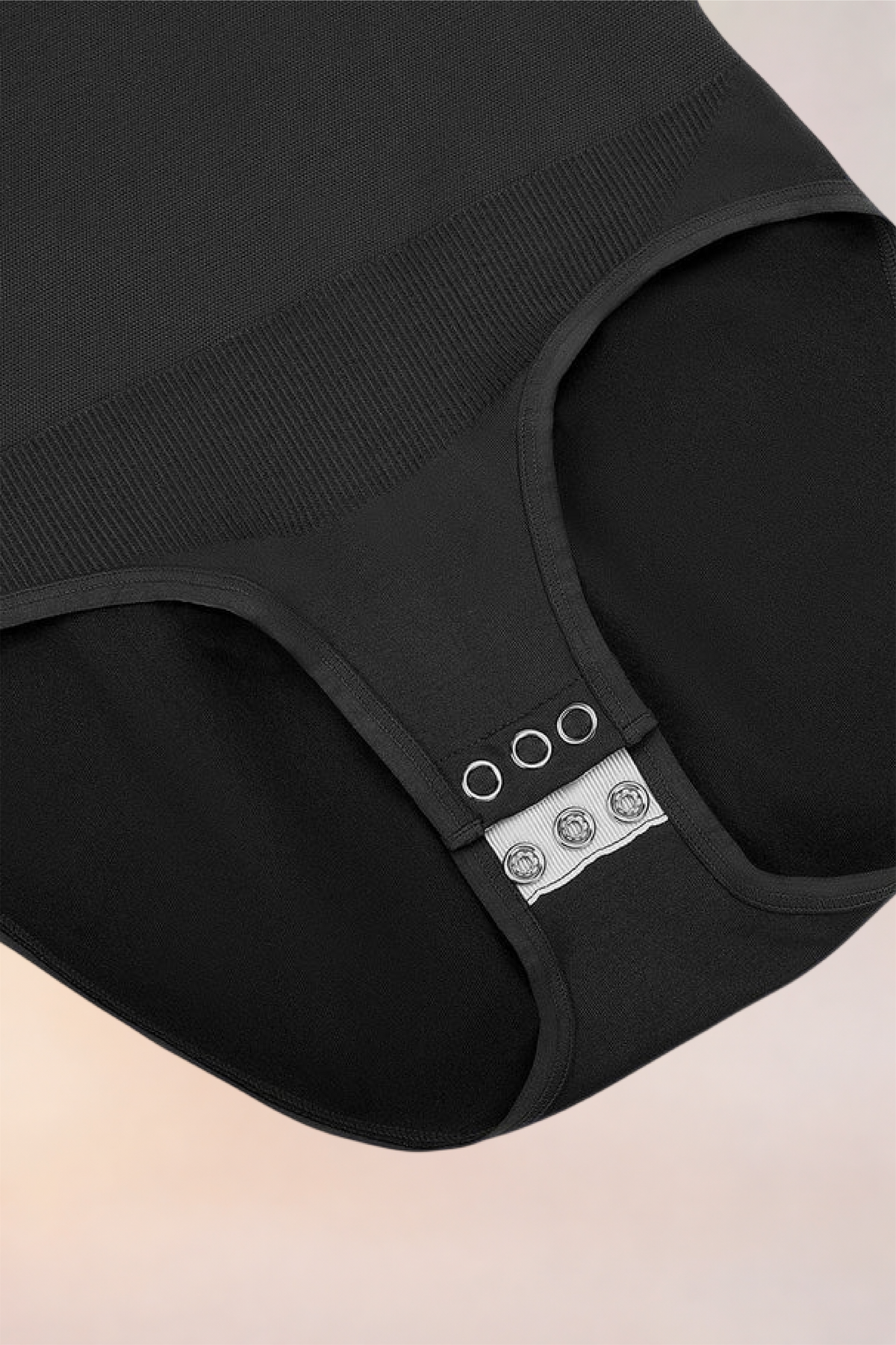 Flat lay of the Skinzform Peach Round-Neck Brief in Noir showing the snap gusset