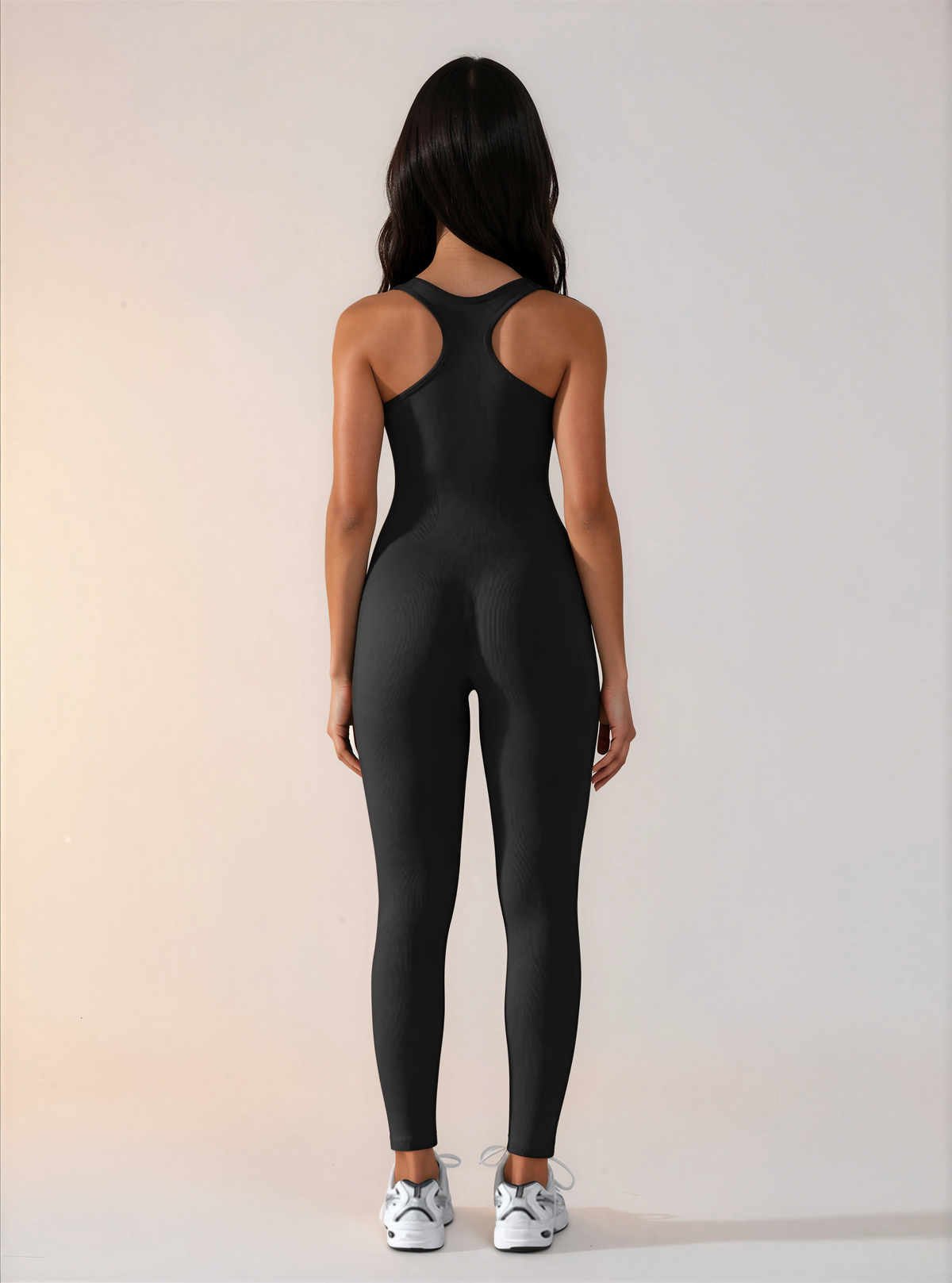 Skinzform Racer Bodysuit in Noir worn with trainers, full-length back view
