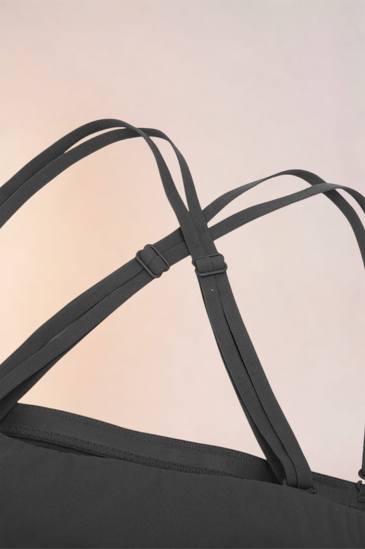 Flat lay of the Skinzform Scoop Bralette in Noir showing the adjustable straps