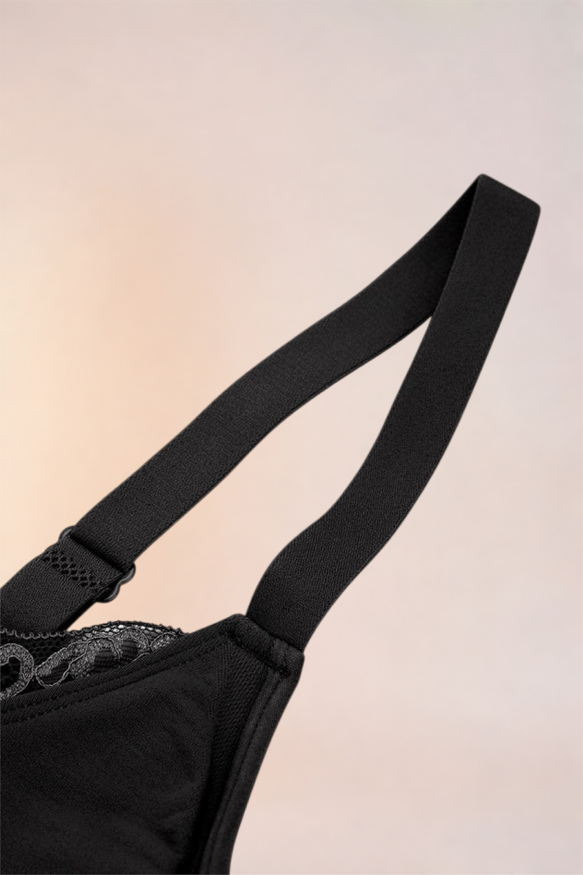 Flat lay of the Skinzform Scoop Bralette in Noir showing the strap and lace-trimmed cup