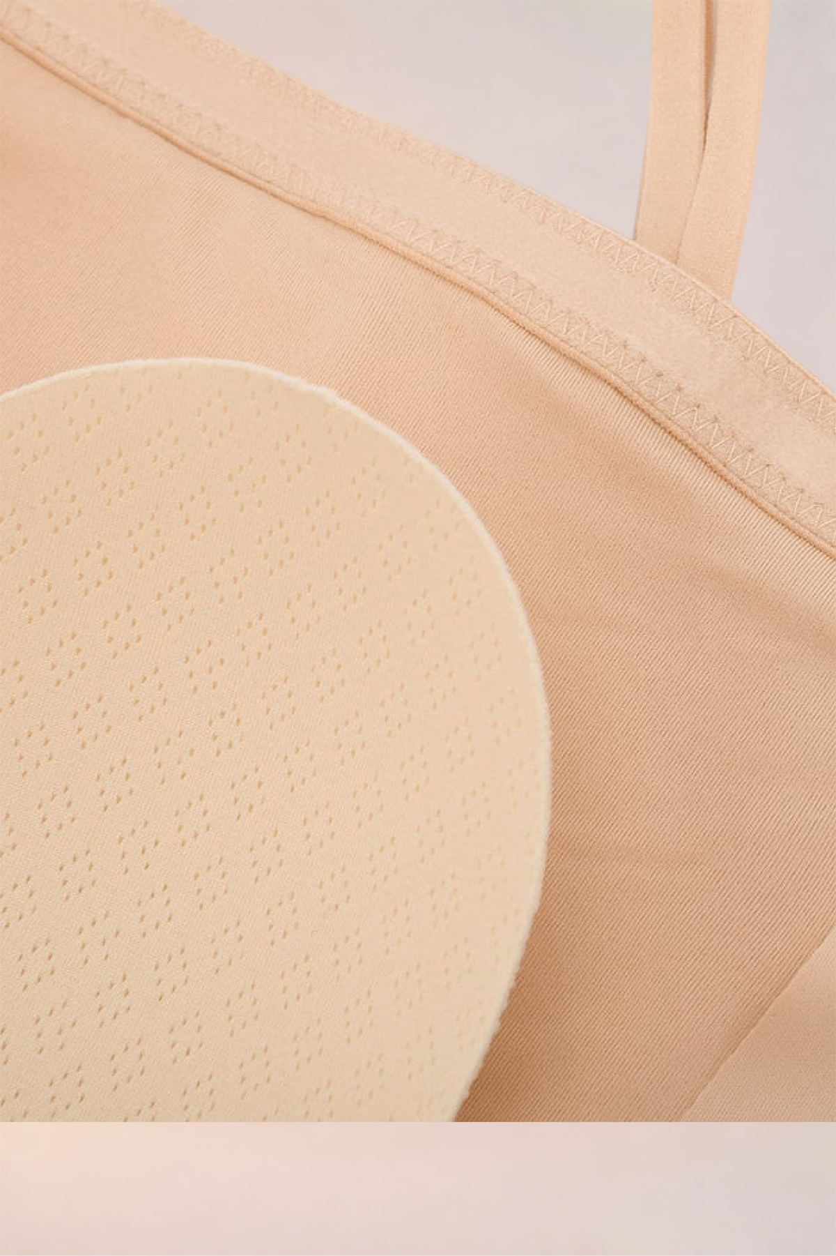 Close-up of a removable pad inside the cup of the Skinzform Scoop Bralette in Nude