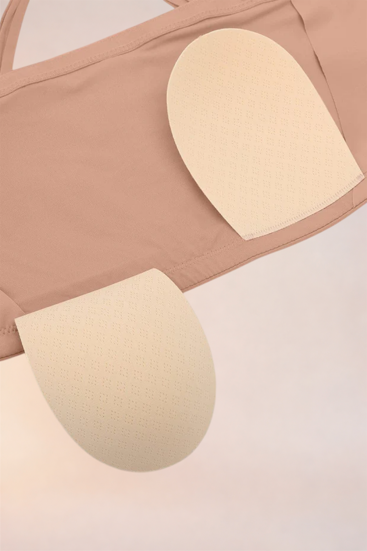 Flat lay of the removable pads for the Skinzform Scoop Bralette in Nude
