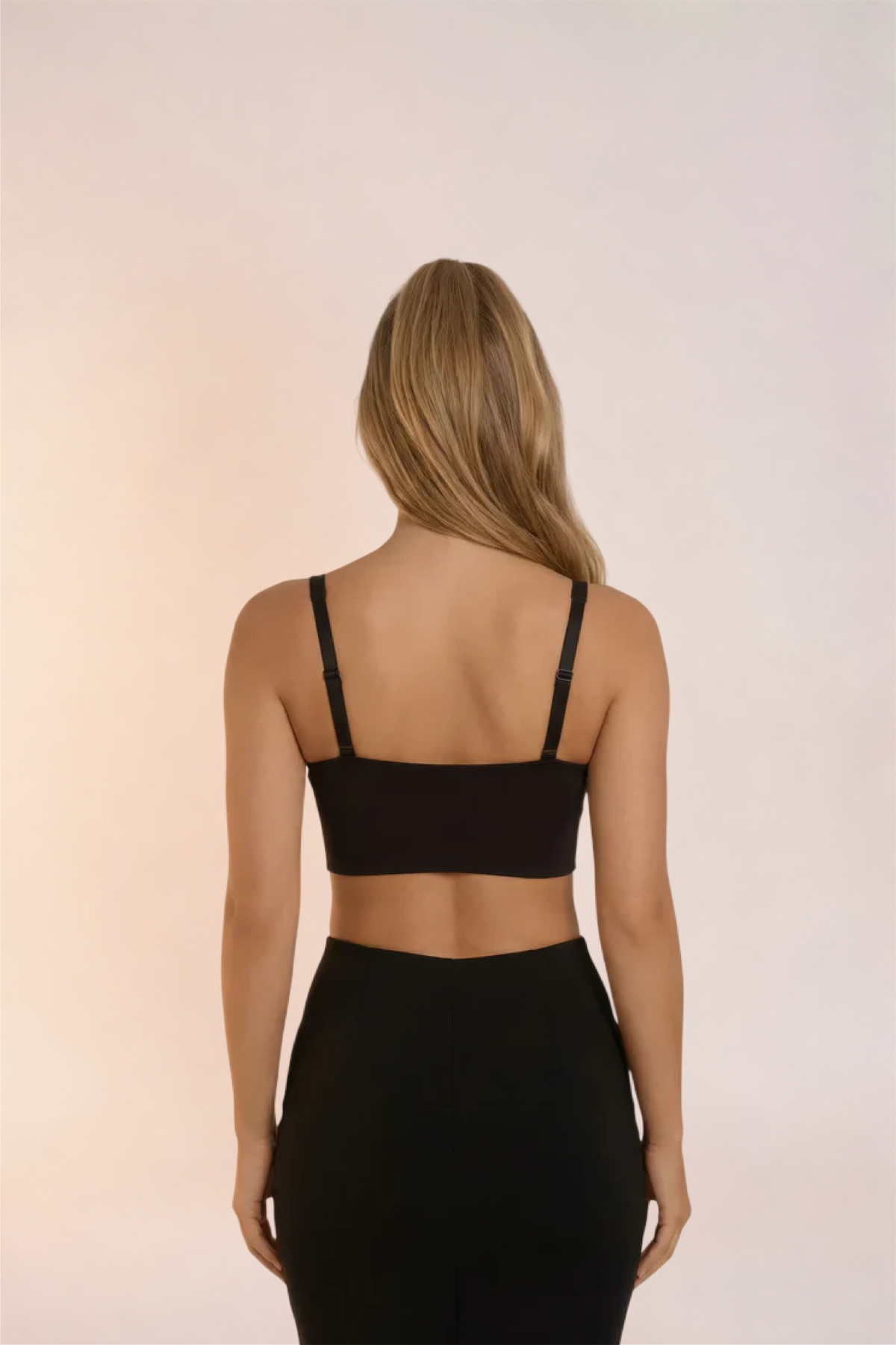 Skinzform Sculpt Bra in Noir styled with a black pencil skirt, back view