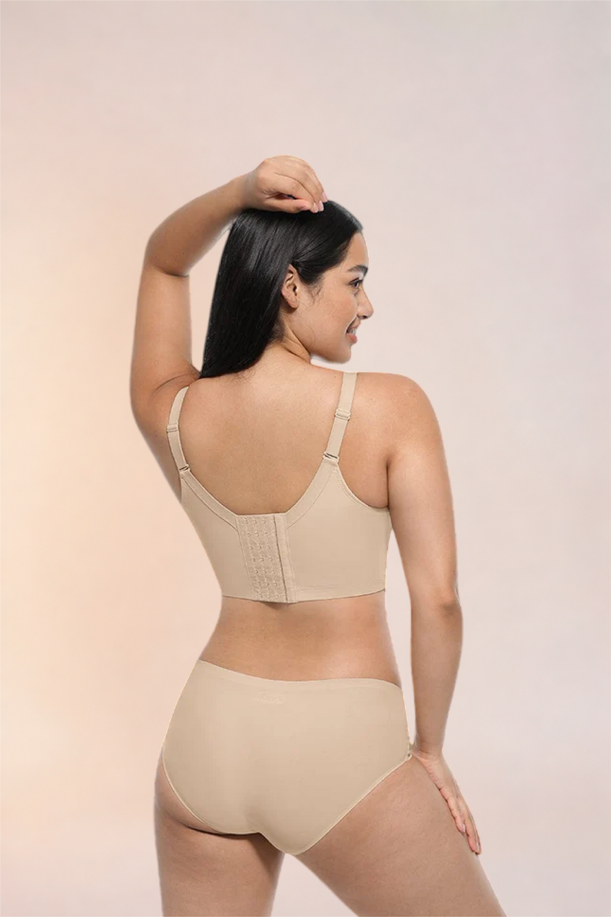 Skinzform Sculpt Bra – Nude - back view with a hand at the head, worn with matching briefs