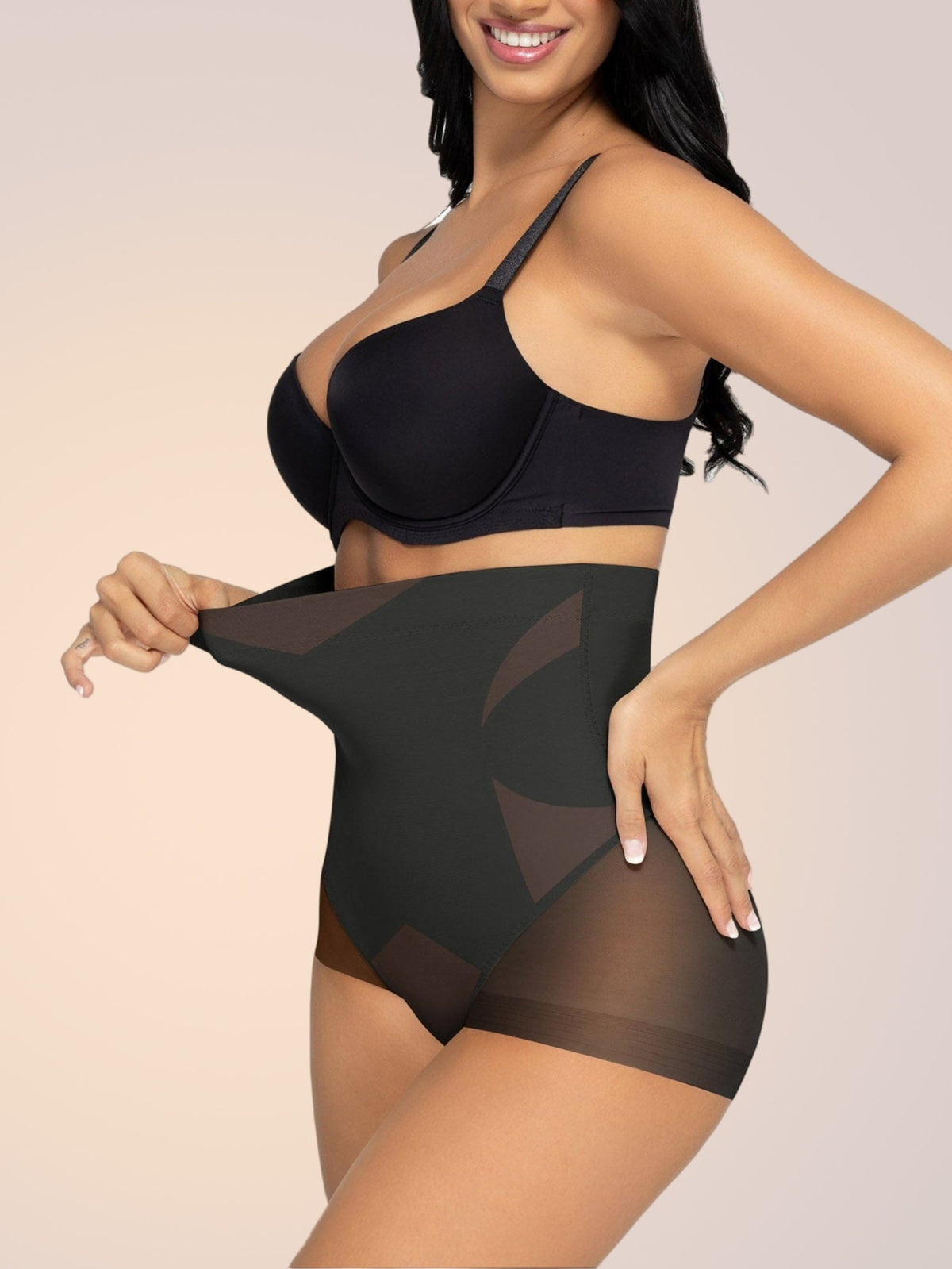 Skinzform Sculpt Brief in Noir, side view - model stretching the waistband to show give