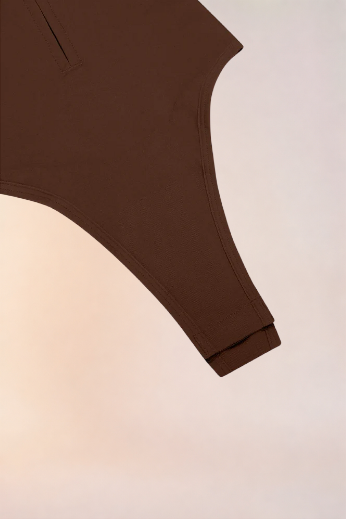 Close-up of the thong-cut gusset on the Skinzform Séjour Bodysuit in Cacao
