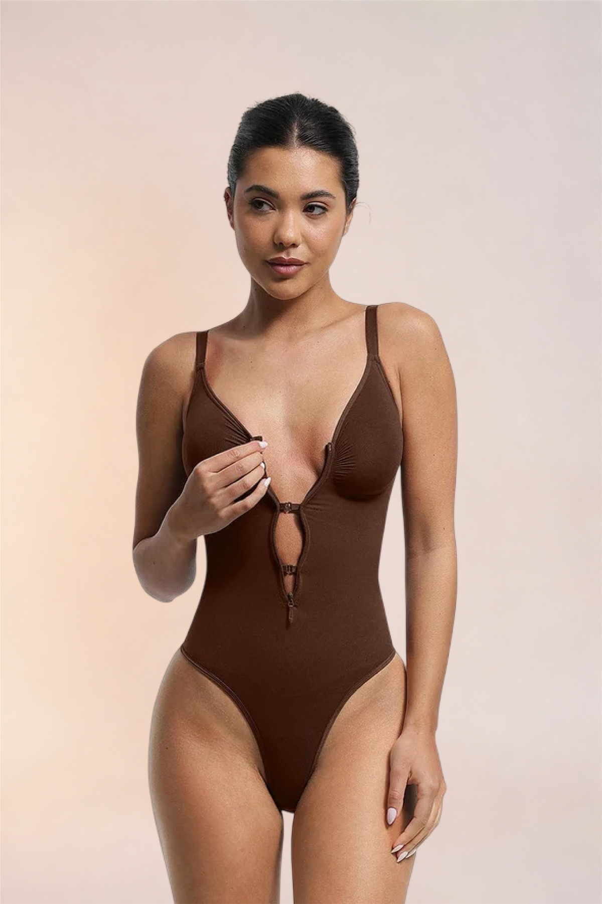 Skinzform Séjour Bodysuit in Cacao - model opening the front zip