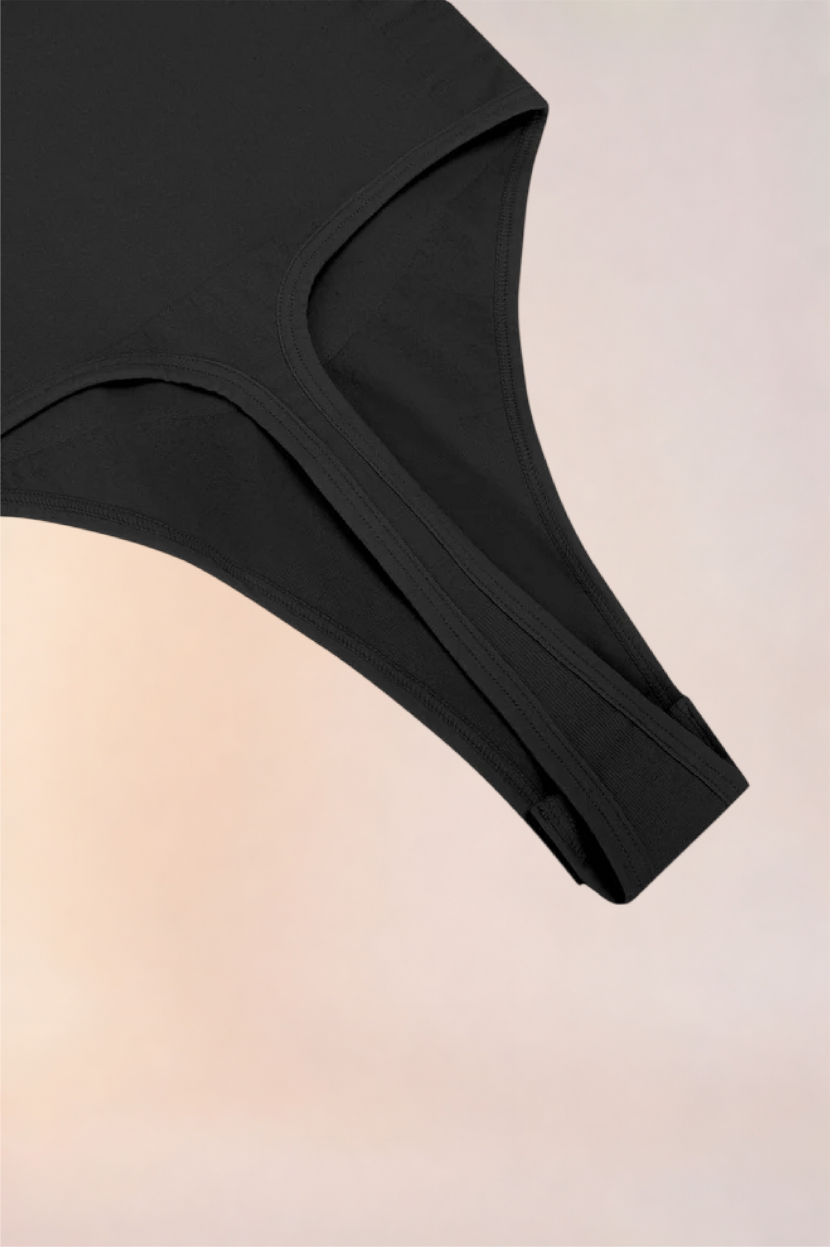 Close-up of the thong-cut gusset on the Skinzform Séjour Bodysuit in Noir