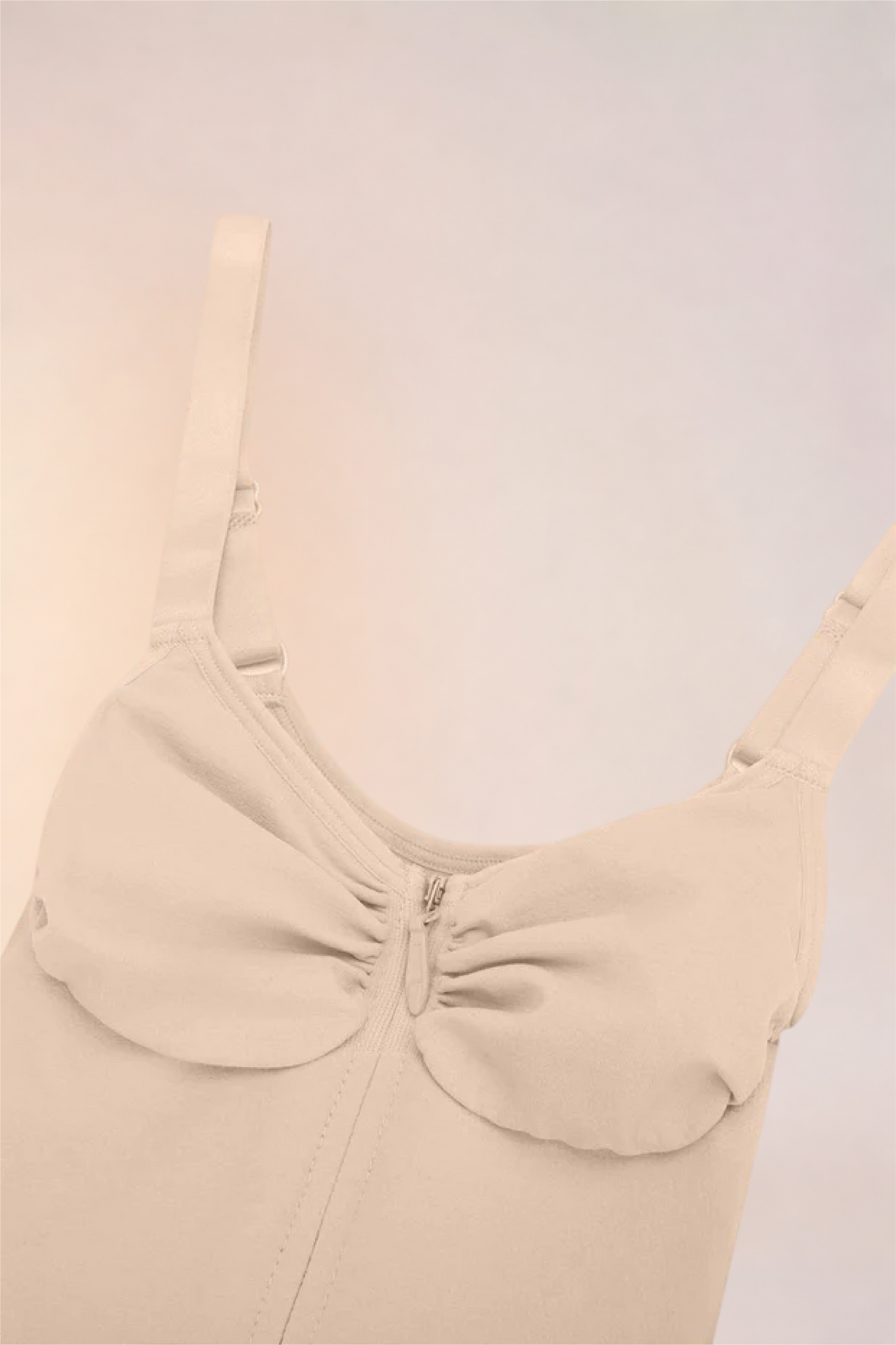 Close-up of the moulded cups and ruched centre on the Skinzform Séjour Bodysuit in Nude