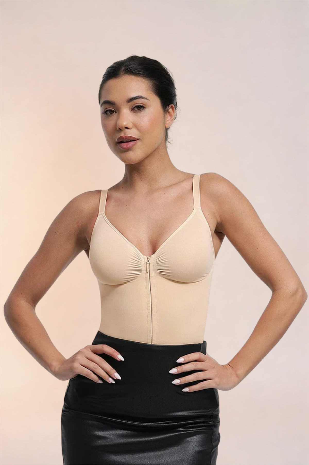 Skinzform Séjour Bodysuit in Nude styled with a black leather skirt, front view