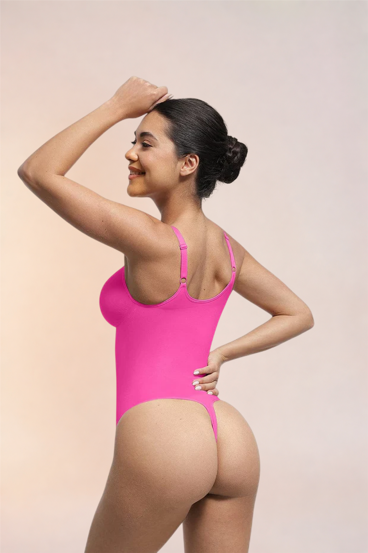 Skinzform Séjour Bodysuit in Rose, angled back view on the model