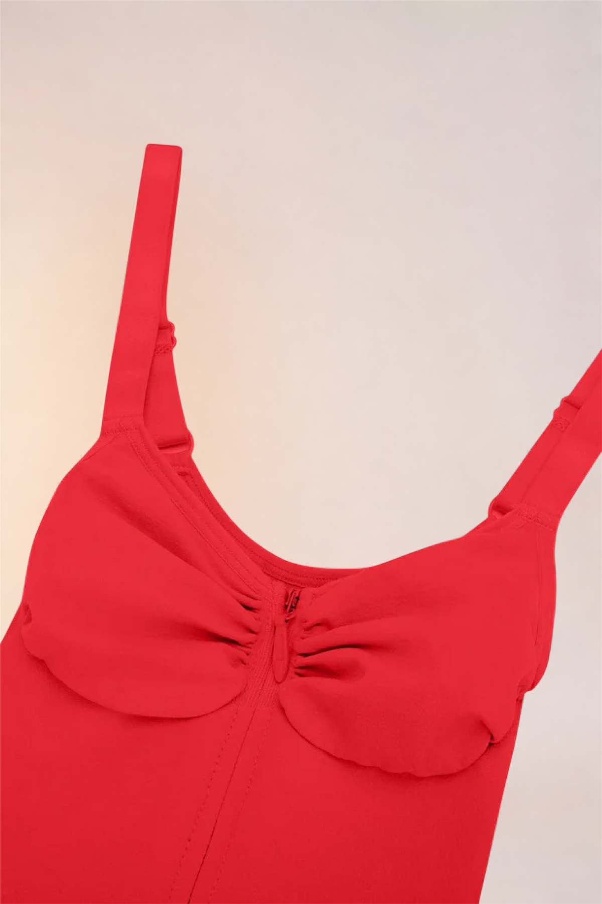 Close-up of the moulded cups and ruched centre on the Skinzform Séjour Bodysuit in Rouge