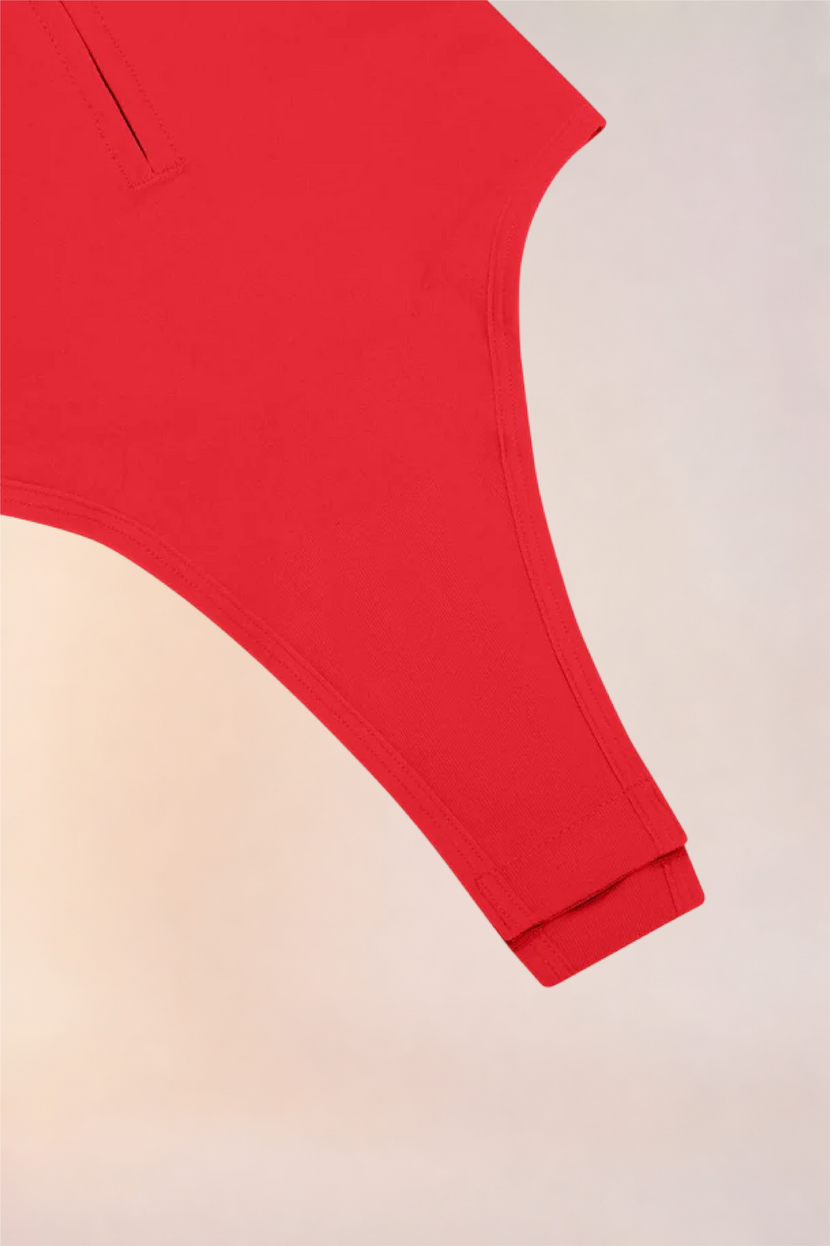 Close-up of the thong-cut gusset on the Skinzform Séjour Bodysuit in Rouge