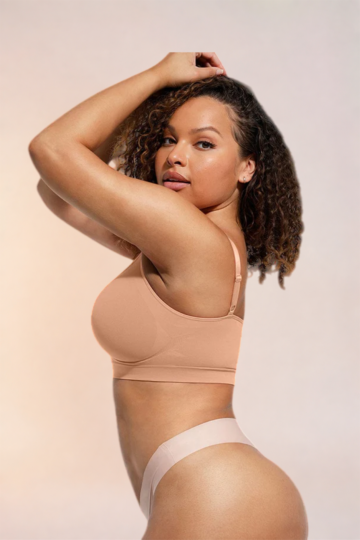 Skinzform Soutien Bra in Beige, side view on the model with one arm raised