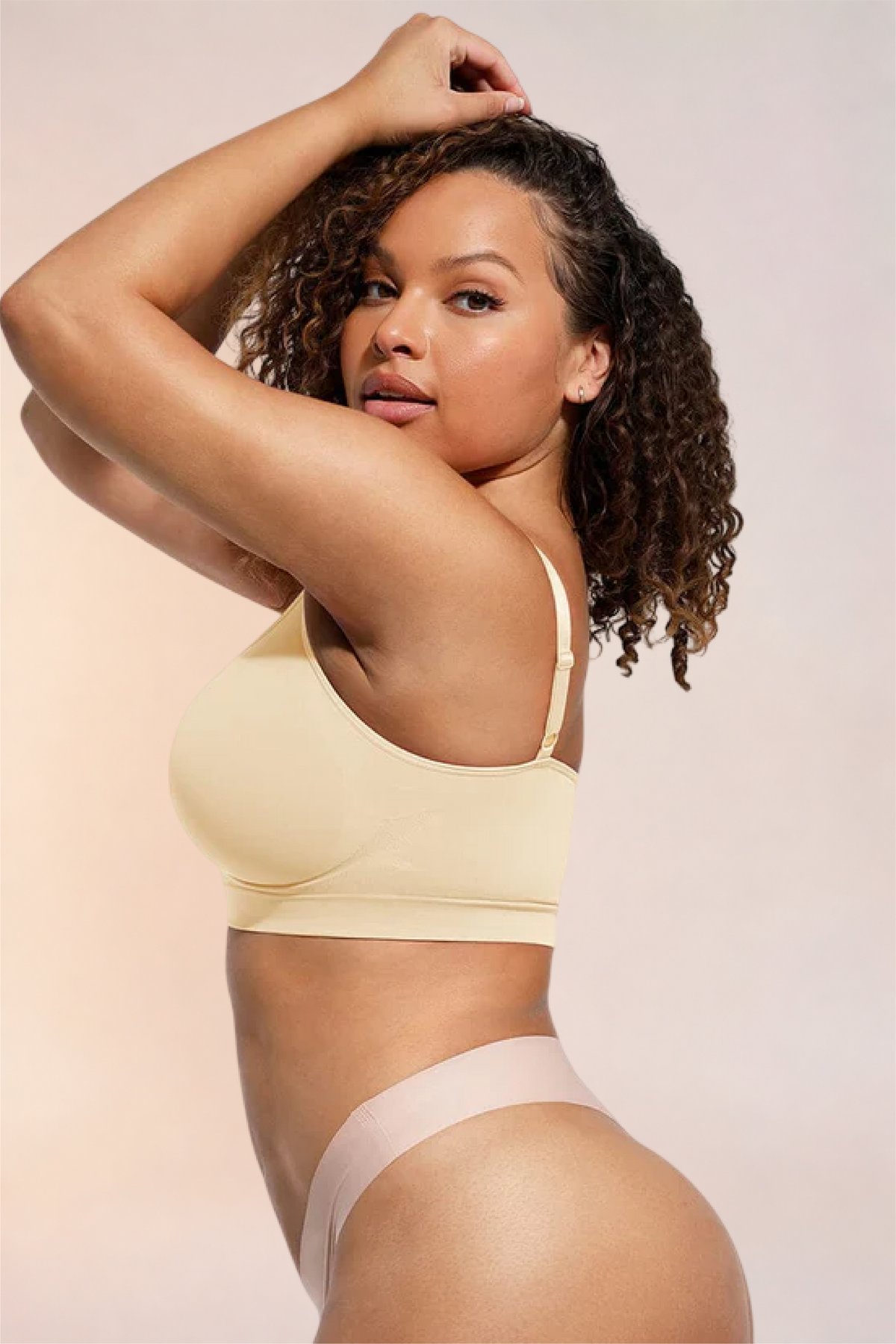 Skinzform Soutien Bra in Nude - half-length front view with arms raised