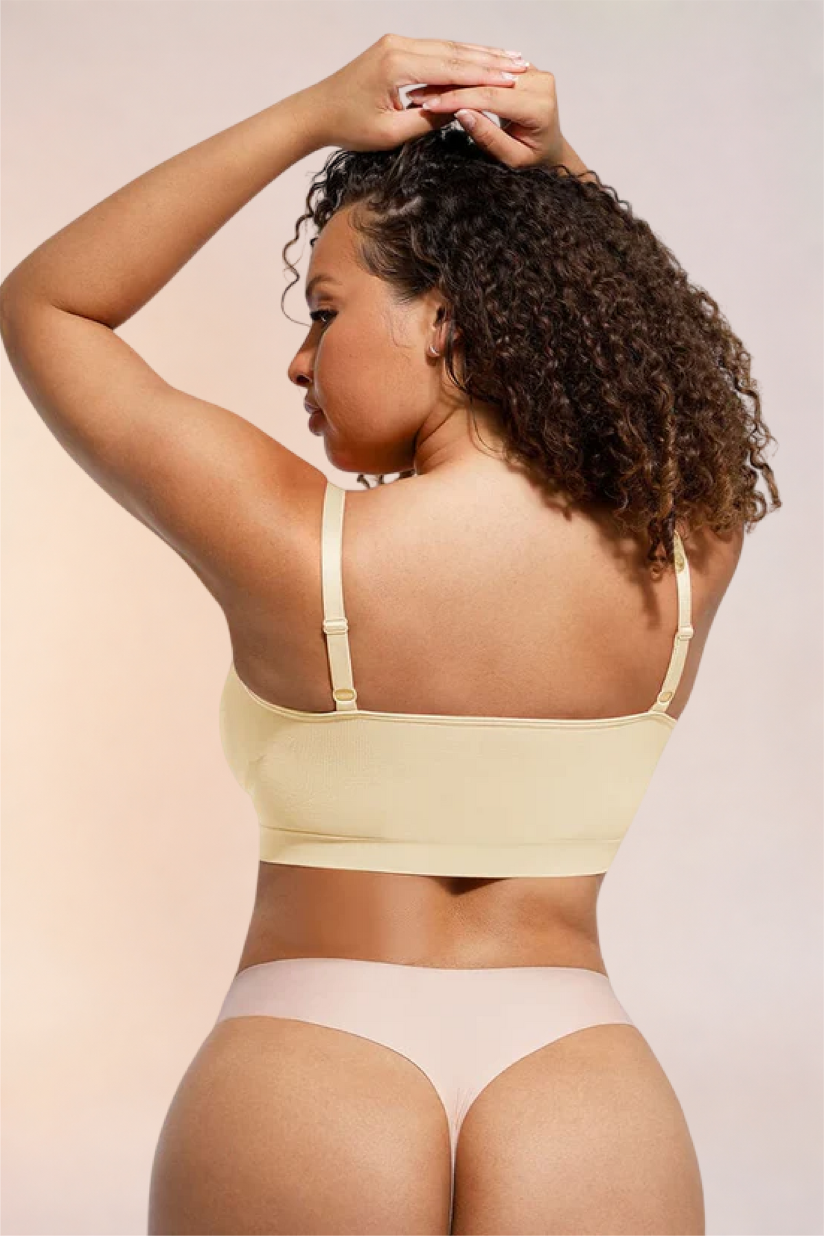 Skinzform Soutien Bra in Nude, back view with arms raised