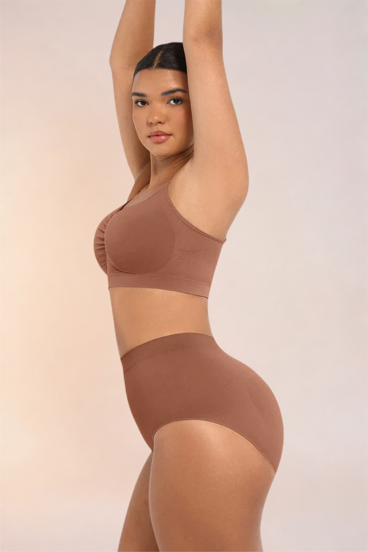 Skinzform Soutien Bra in Tan, side view on the model with one arm raised